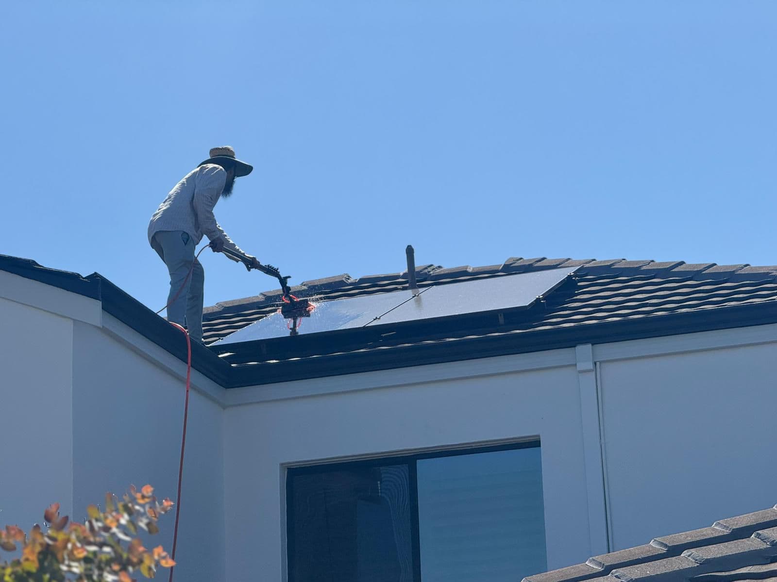 Technician cleaning solar panels in Perth